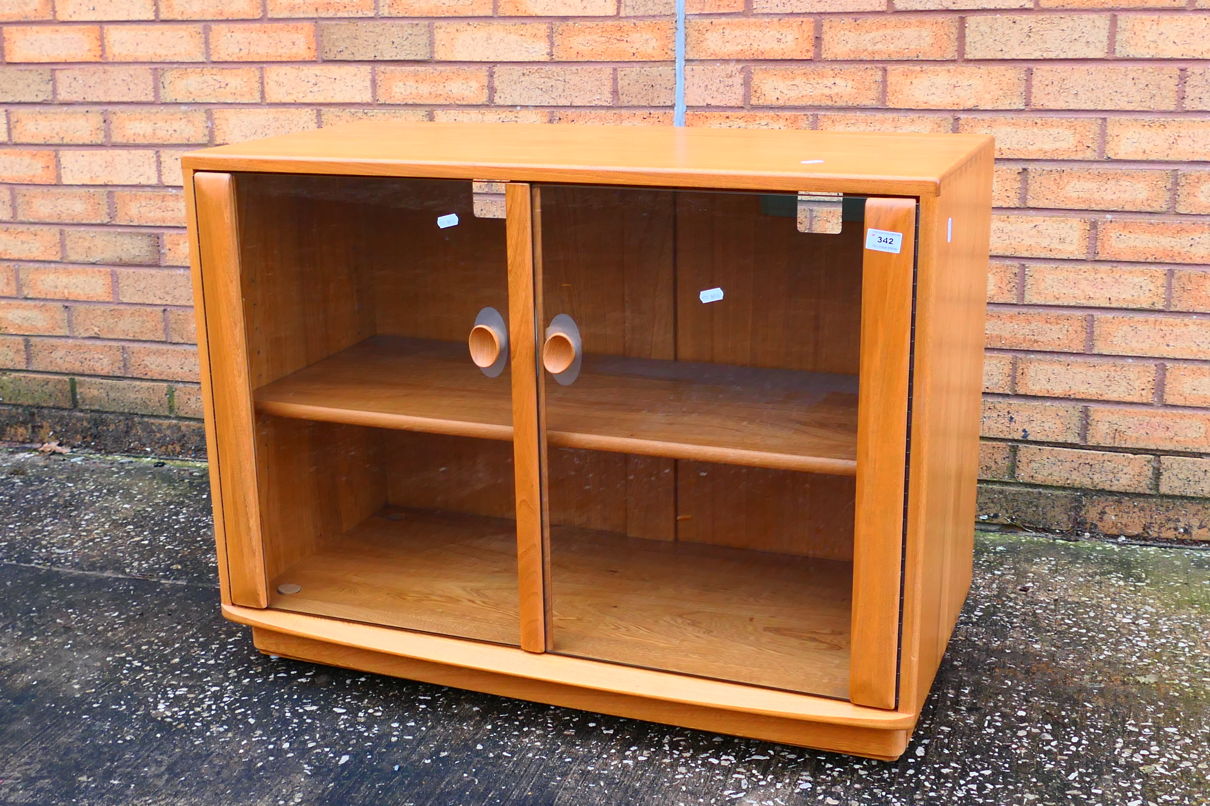 Ercol - A Windsor twin door display cabinet or glazed bookcase, approximately 68 cm x 92 cm x 44 cm.