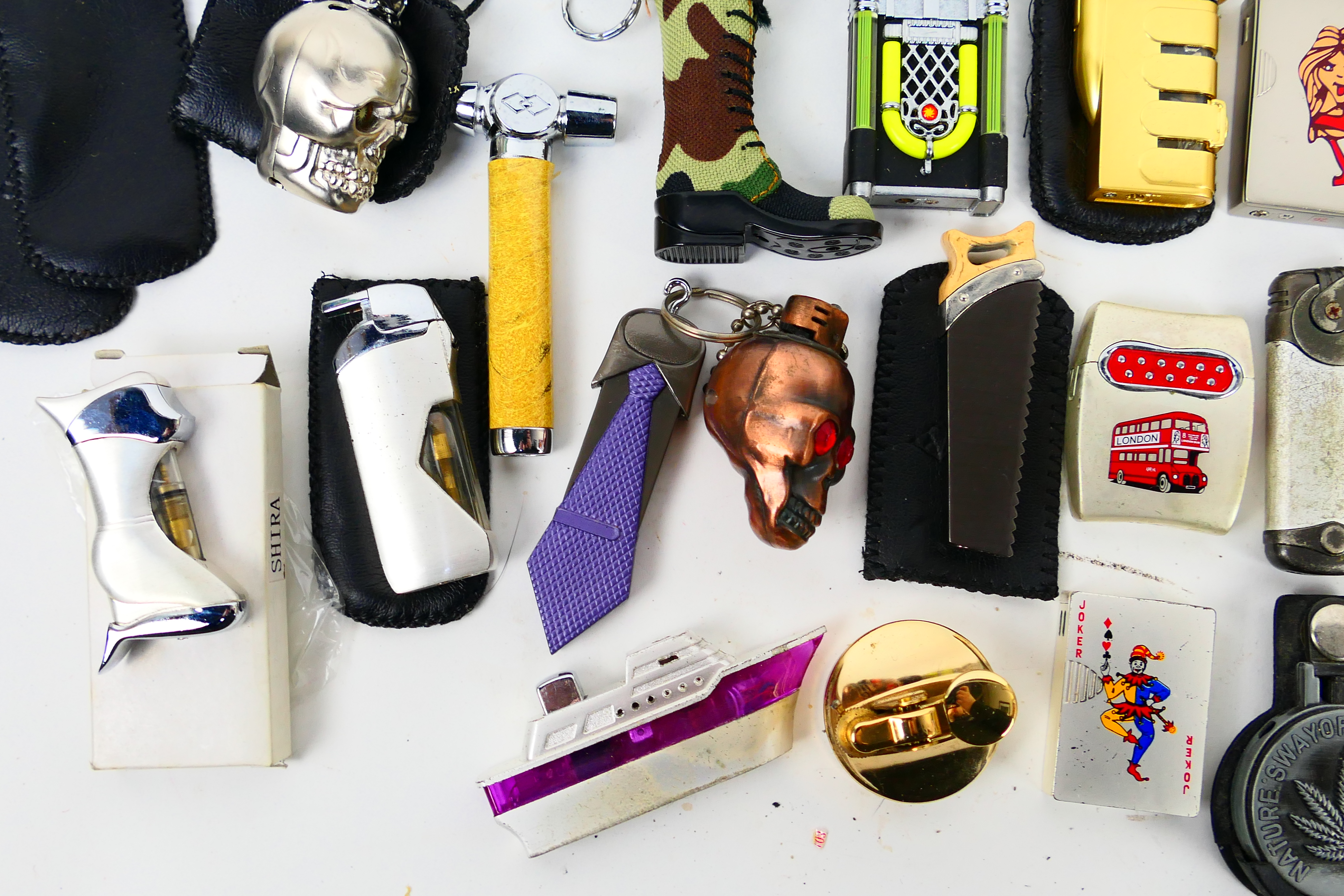 A collection of novelty cigarette lighters and protective cases. - Image 3 of 7