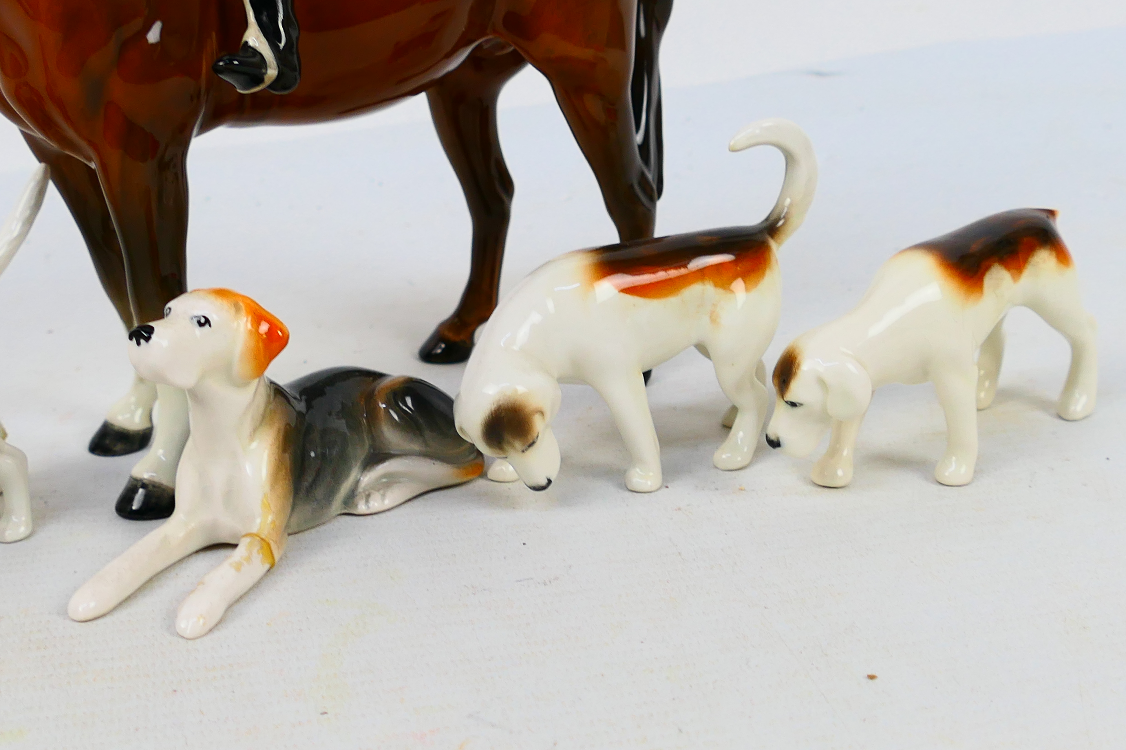 A Beswick huntswoman figure, 21 cm (h), four fox hounds and a fox figure. - Image 4 of 9