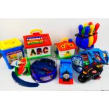 Duplo - Tomy - A collection of plastic toys including a bucket of Stickle Bricks, a Tomy train,