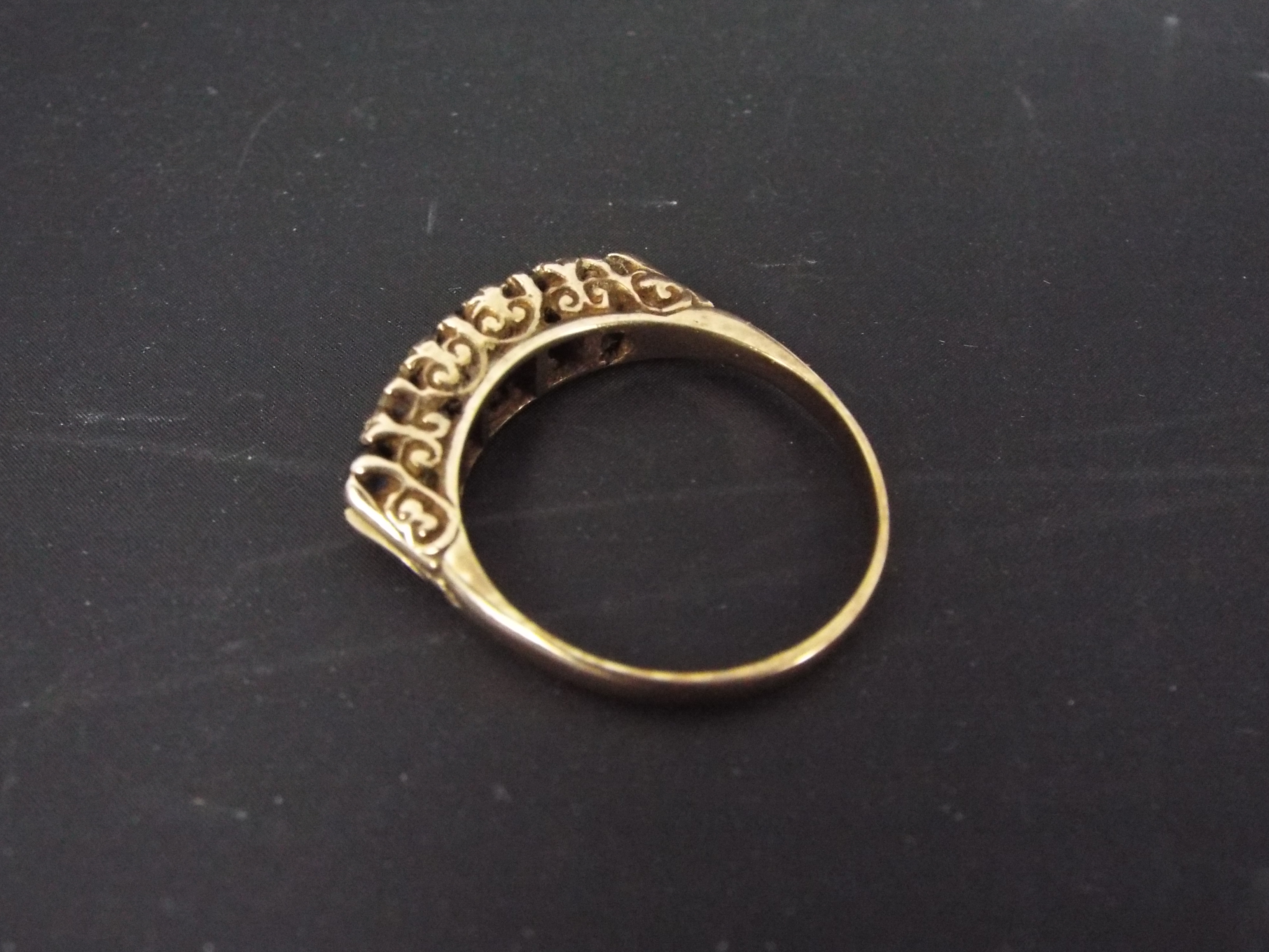 A rose metal five stone ring, marks indistinct, size N+½, approximately 4.5 grams. - Image 2 of 2