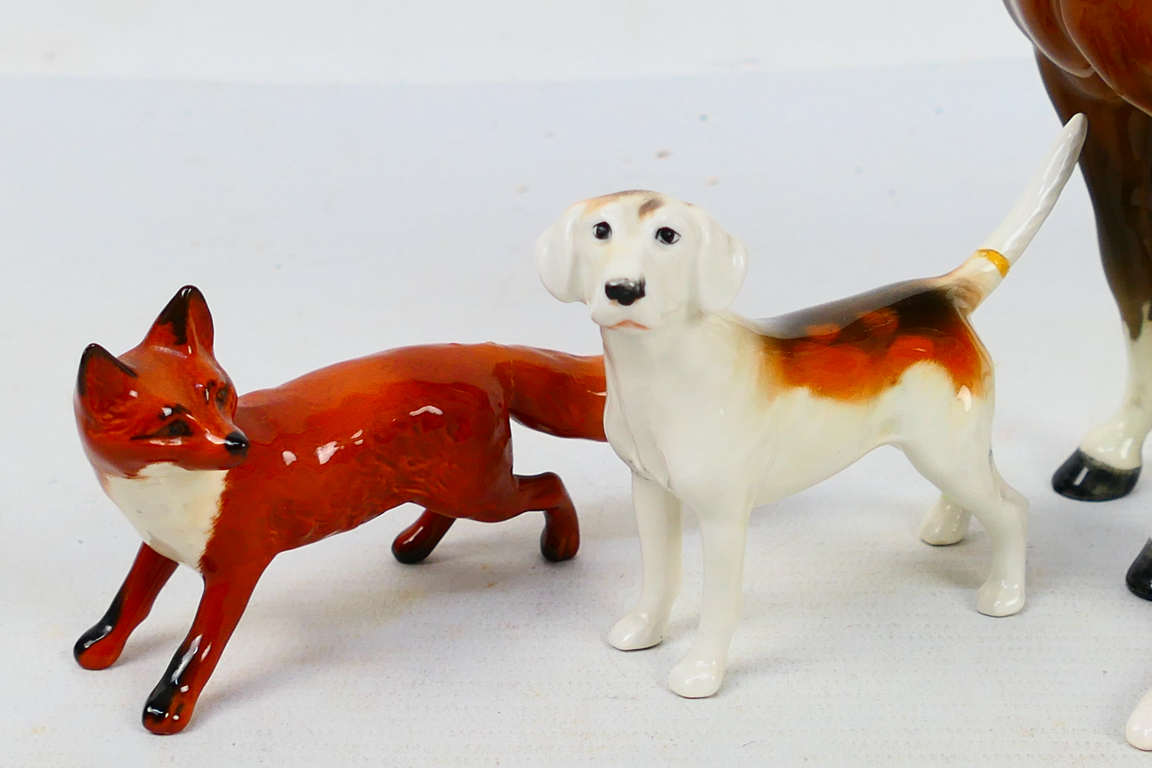 A Beswick huntswoman figure, 21 cm (h), four fox hounds and a fox figure. - Image 3 of 9