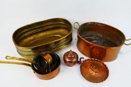 A collection of metalware, copper and brass.