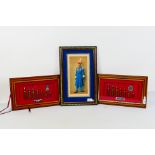 Two framed cap badge and bullet displays