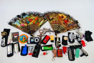 Lot to include novelty cigarette lighters, protective cases, hand fans, bottle openers and other.