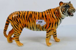 A Beswick study of a tiger, approximately 30 cm (l).