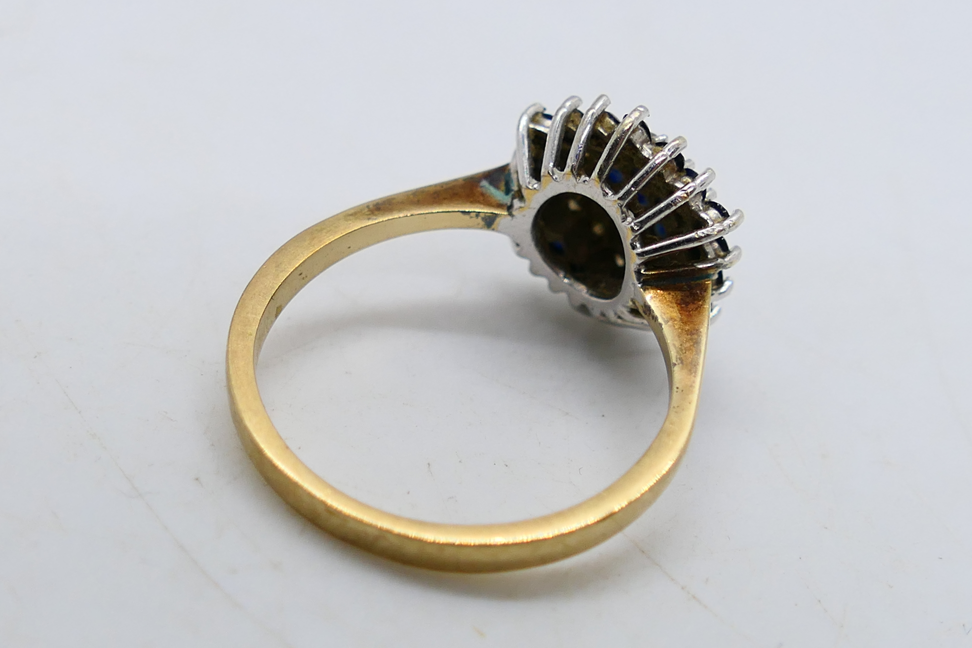 A 9ct yellow gold diamond and sapphire cluster ring, size N, approximately 2.5 grams. - Image 3 of 4