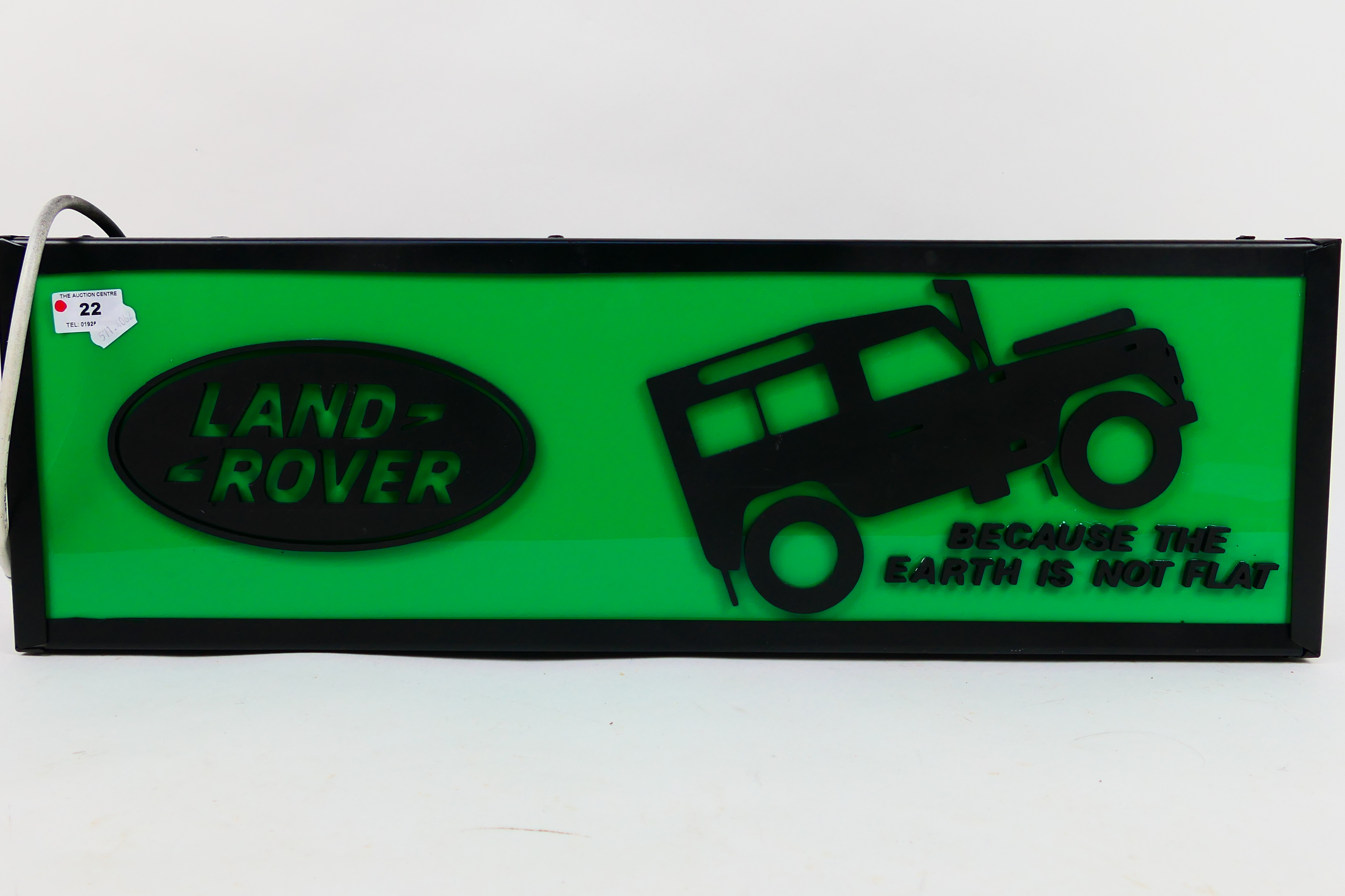 A Land Rover illuminated light box sign, approximately 21 cm x 66 cm x 10 cm.