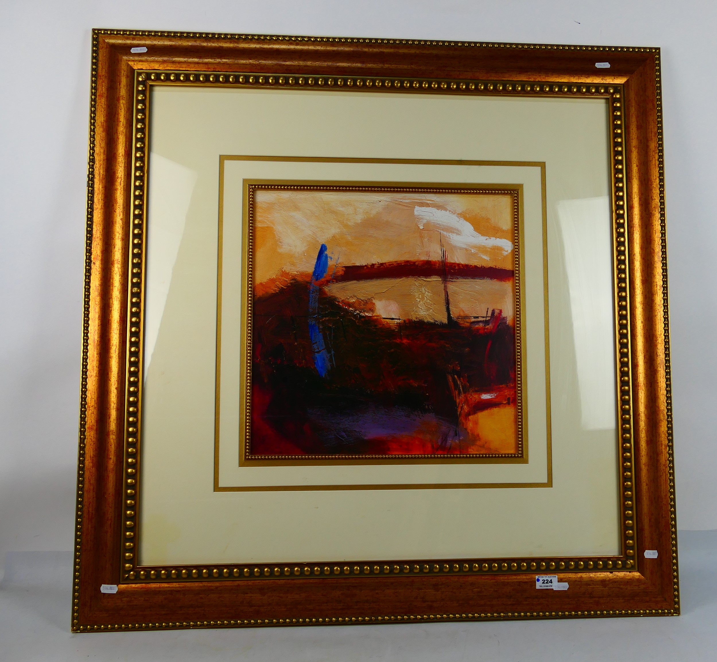 A decoratively framed abstract print, mounted and framed under glass,