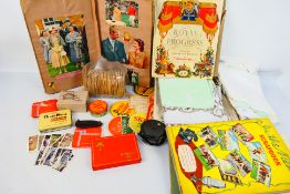 A mixed lot to include vintage linen, royal related scrapbooks and ephemera, fishing reel,