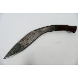 A vintage kukri knife with 29 cm (l) blade and wooden hilt.