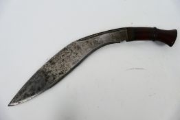 A vintage kukri knife with 29 cm (l) blade and wooden hilt.
