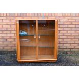 Ercol - A Windsor twin door display cabinet with adjustable glass shelves,