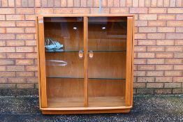 Ercol - A Windsor twin door display cabinet with adjustable glass shelves,