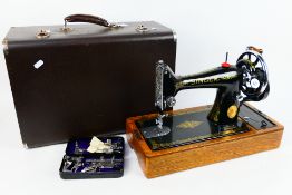 A vintage EB series Singer sewing machine, black with gilt decoration,