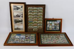 Four framed displays of railway related cigarette cards and one further similar piece,
