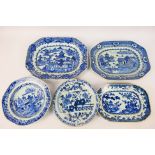 A collection of Chinese blue and white dishes, predominantly decorated with landscape scenes,
