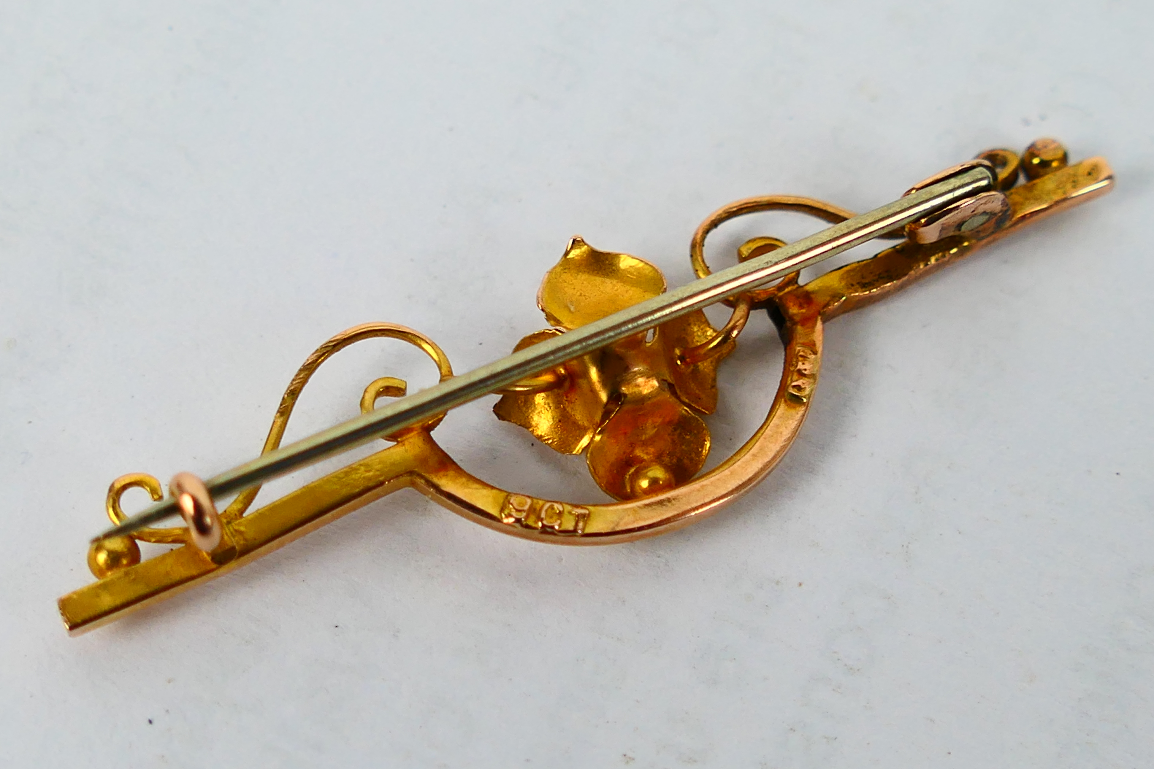 A yellow metal bar brooch with central floral motif, - Image 4 of 5