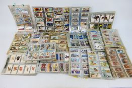 A large quantity of cigarette cards, predominantly housed in plastic sleeves.