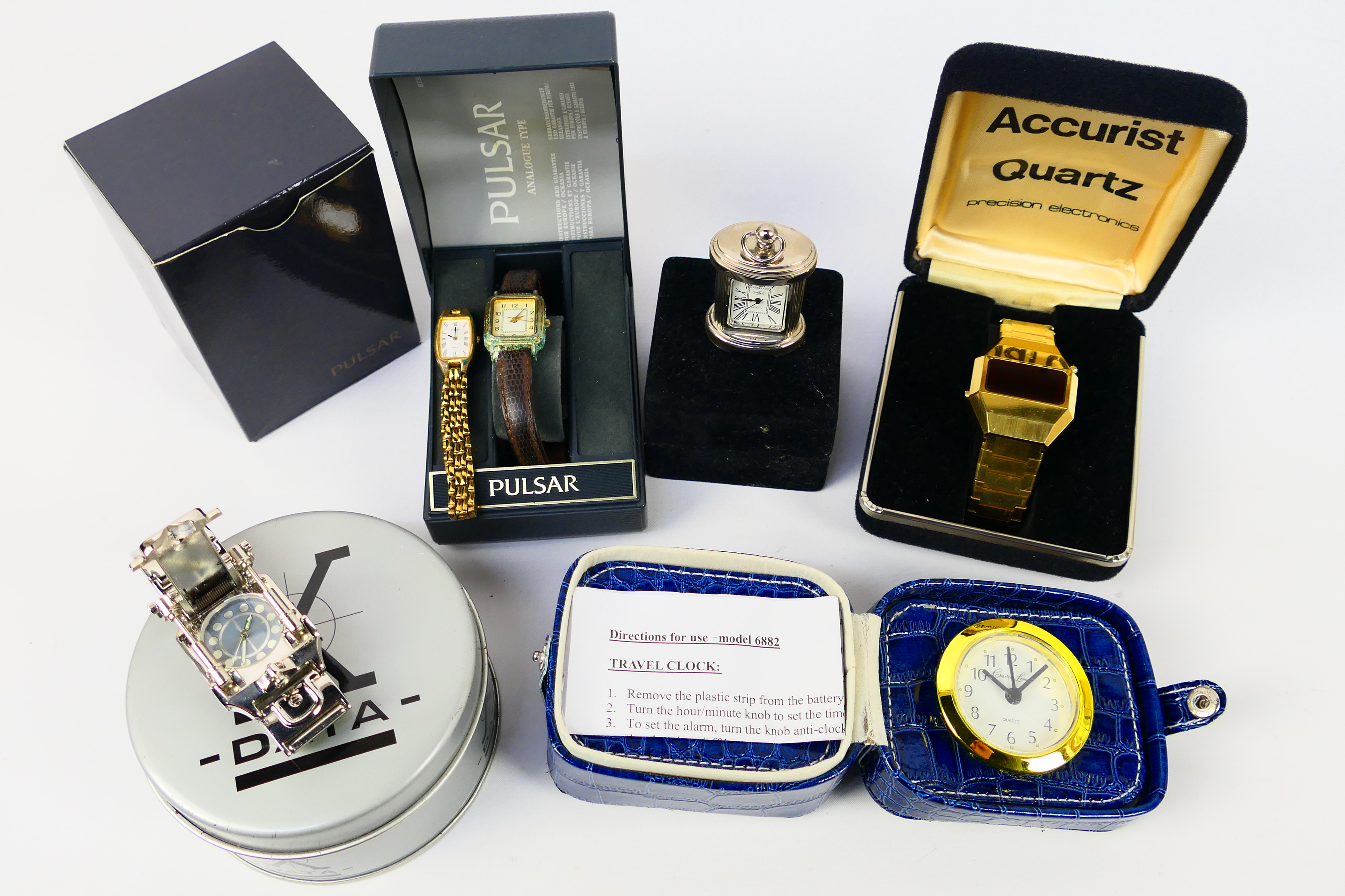 A collection of wrist watches and travel / miniature clocks.