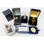 A collection of wrist watches and travel / miniature clocks.