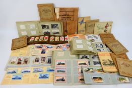A collection of cigarette card albums to include railway, aviation, flora,