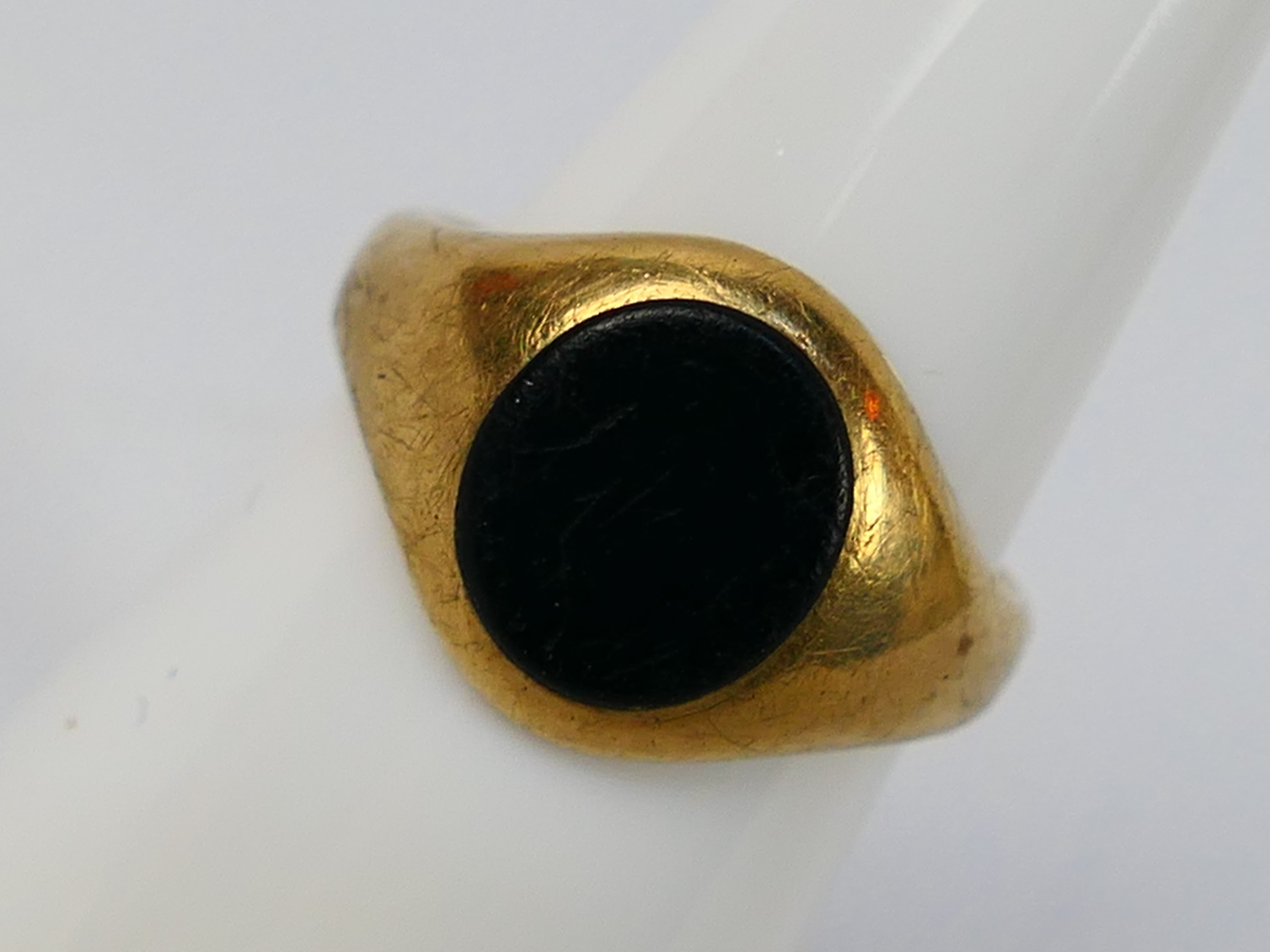 A 9ct yellow gold and onyx signet ring, size K+½, approximately 4.3 grams.