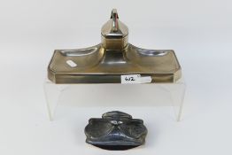 A white metal Art Deco desk stand with central covered inkwell and an Art Nouveau style rocker