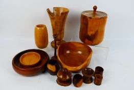 A collection of treen to include vases, bowls and similar.
