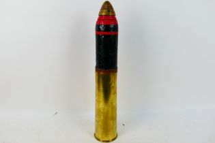 A World War One (WW1 / WWI) British 18 Pounder artillery shell projectile with fuze and brass shell