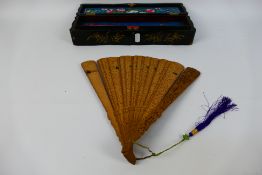 A late 19th or early 20th century carved sandalwood brise fan,