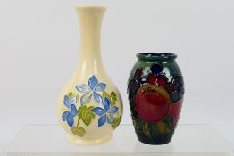 Moorcroft - Two small Moorcroft Pottery vases comprising a solifleur vase decorated in the