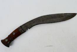 A vintage kukri with 30 cm (l) blade, wooden hilt and steel chapri.