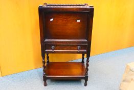 An antique pot cupboard with sliding top section for access, single door and under tier,