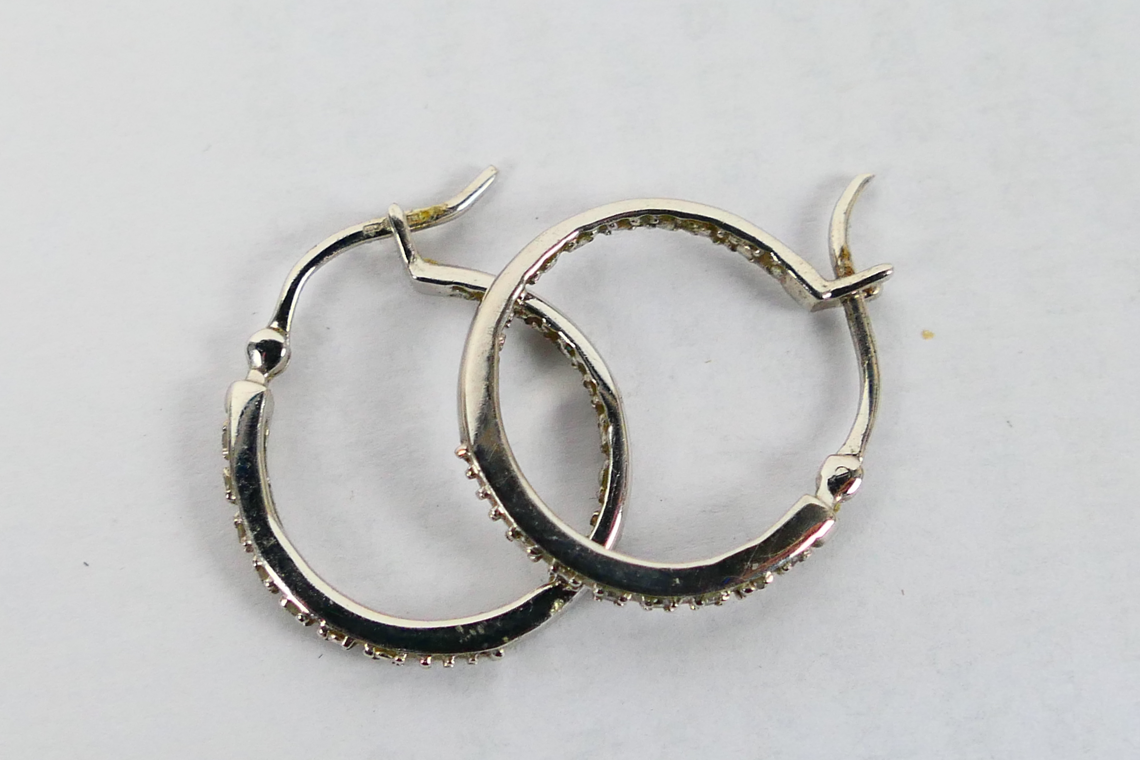 A pair of 9ct white gold, stone set ear hoops, approximately 2.7 grams. - Image 3 of 3