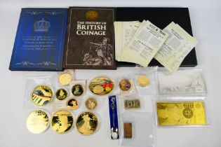 A collection of various gold plated commemorative coins and ingots,