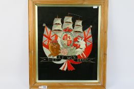 A British naval embroidery comprising Royal Coat Of Arms imposed before a three masted ship with