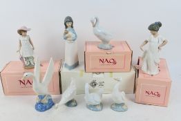 A collection of Nao figures, part boxed, largest approximately 24 cm (h).