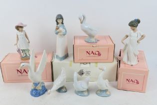 A collection of Nao figures, part boxed, largest approximately 24 cm (h).