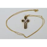 A 9ct yellow gold, stone set crucifix pendant on yellow metal chain stamped 375, approximately 3.