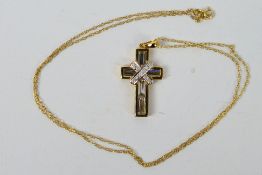 A 9ct yellow gold, stone set crucifix pendant on yellow metal chain stamped 375, approximately 3.