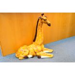 A large Italian ceramic study of a recumbent giraffe, approximately 90 cm (h).