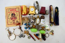 A group of small collectables to include cheroot holder, white metal thimble, watch,