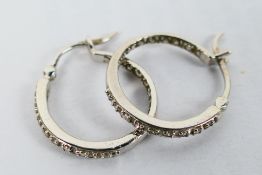 A pair of 9ct white gold, stone set ear hoops, approximately 2.7 grams.