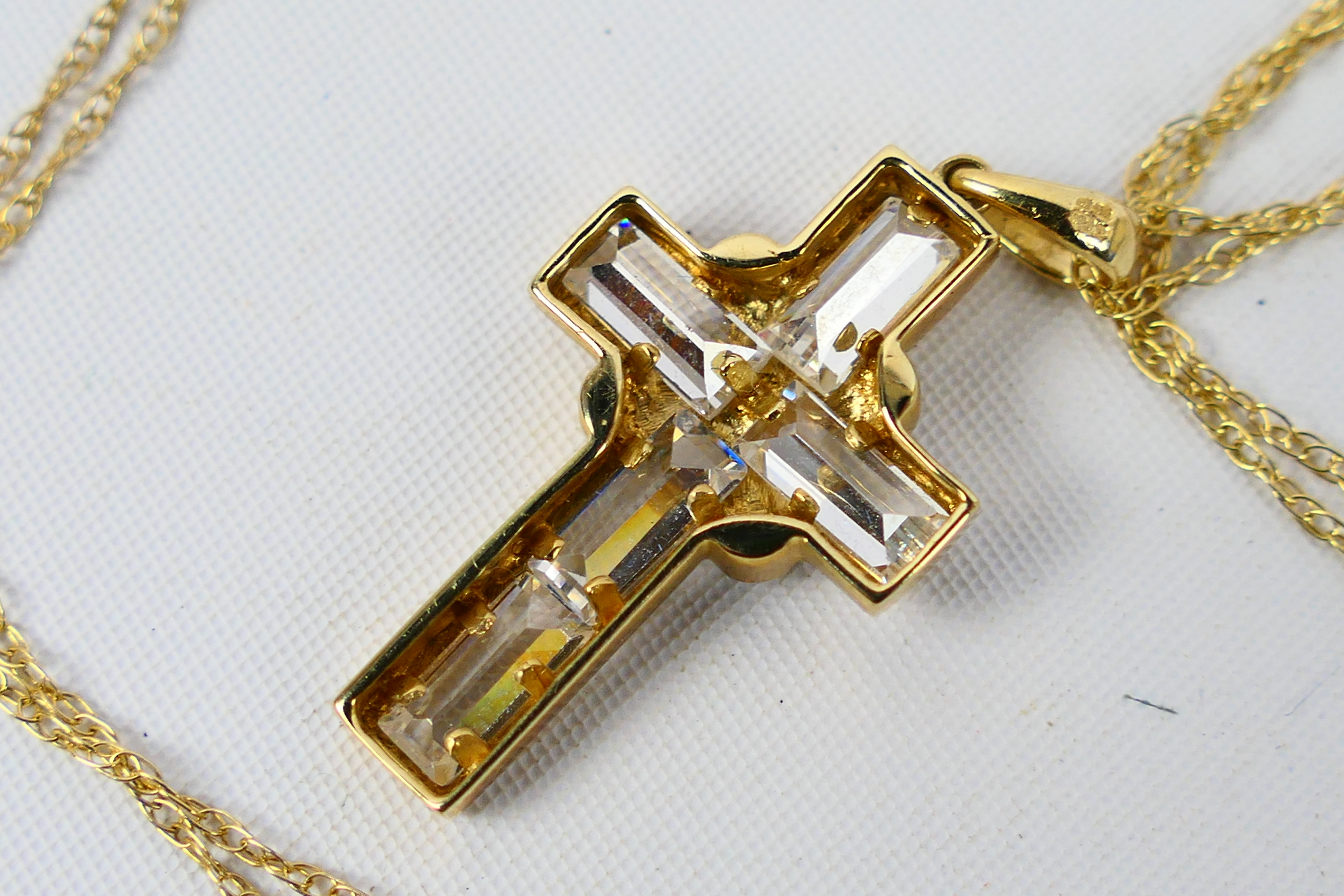 A 9ct yellow gold, stone set crucifix pendant on yellow metal chain stamped 375, approximately 3. - Image 3 of 3