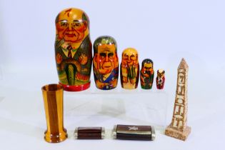 A set of Russian president matryoshka dolls, two wood and white metal snuff boxes,