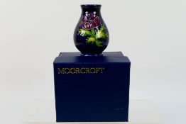 Moorcroft - A small Moorcroft Pottery vase of baluster form, decorated in the Anemone pattern, 1994,