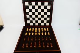 A World Chess Federation chess set and board, board 53 cm x 53 cm and with 9 cm (h) king.