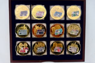 A set of British Banknote Collection commemorative coins comprising twelve gold plated coins each