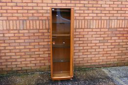 Ercol - A Windsor single door display cabinet with adjustable shelves,